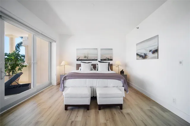 a bedroom with a bed and a potted plant