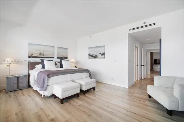 a bedroom with a bed and large window