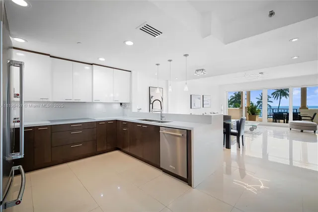 a kitchen with stainless steel appliances a sink and a refrigerator