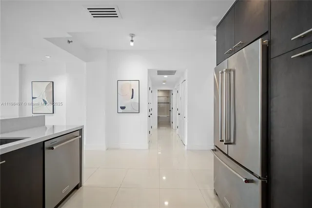 a large kitchen with a refrigerator a sink and a stove