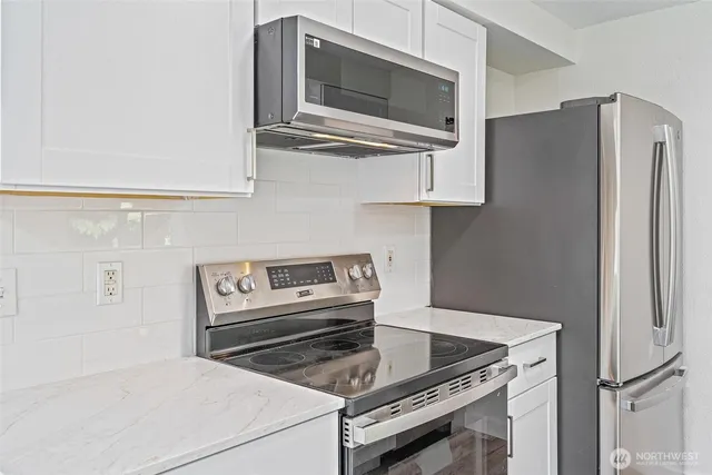 a kitchen with cabinets and stainless steel appliances