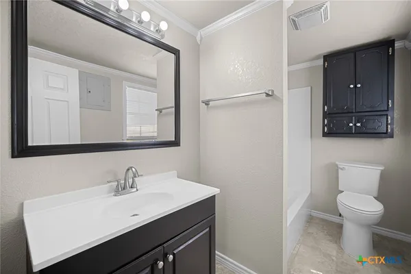 a bathroom with a toilet a sink and a mirror
