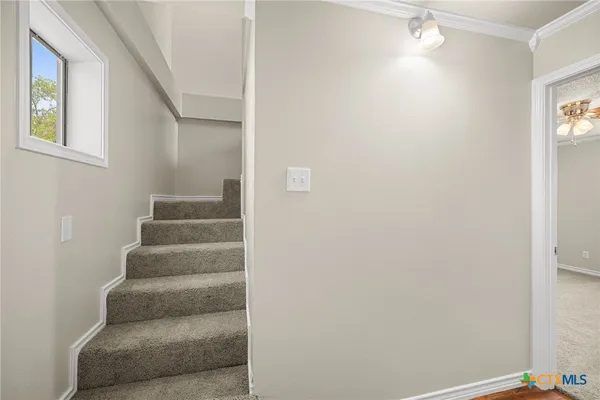 a view of staircase with white walls