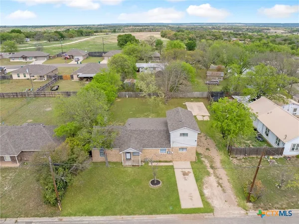 an aerial view of residential houses with outdoor space