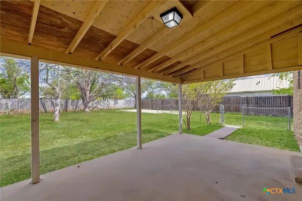 a view of a house with backyard and porch
