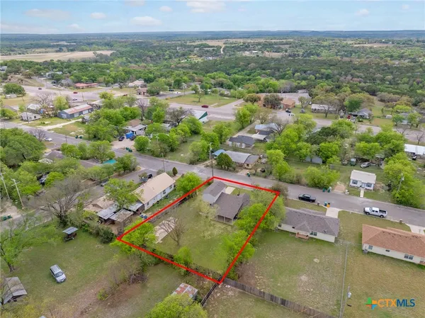 an aerial view of a house with a yard