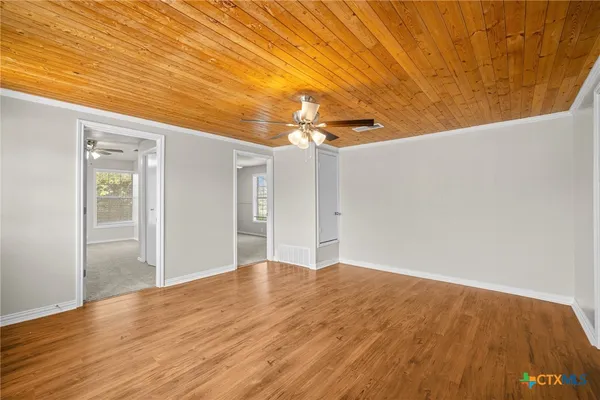 a view of empty room with wooden floor