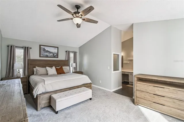 a view of a livingroom with a chandelier fan and a window