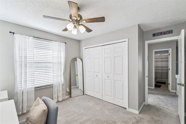an aerial view of a swimming pool with outdoor seating