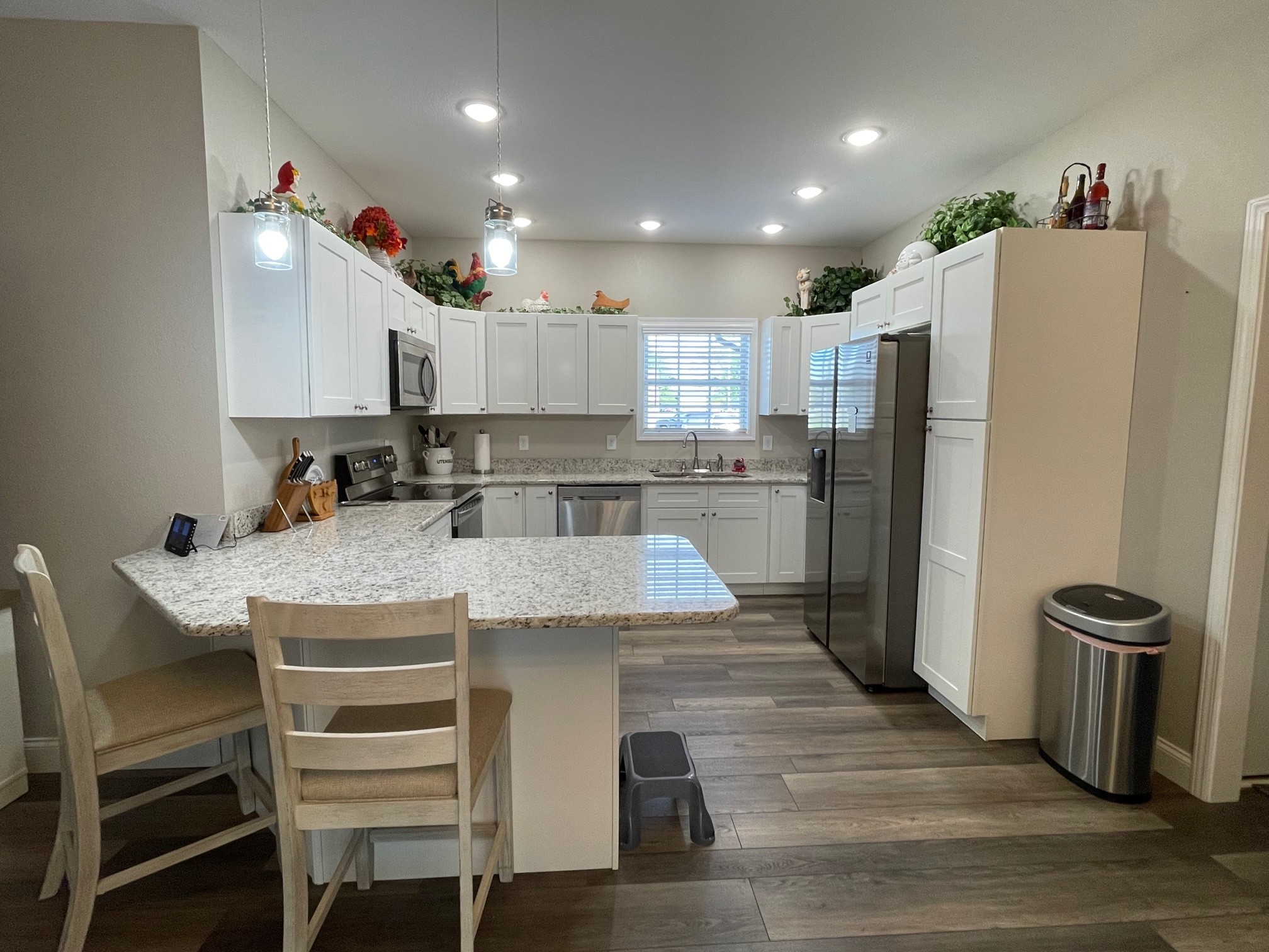 106 Maca Ridge Circle Clarkrange, TN 38553 - Photo 12 of 39 a kitchen with kitchen island a stove a refrigerator and a dining table with wooden floor