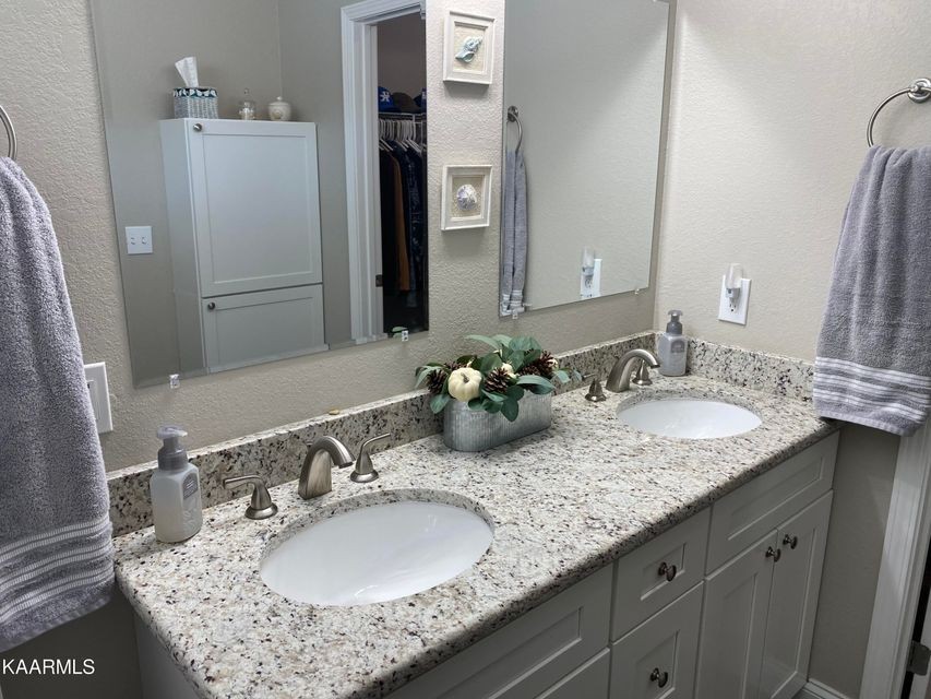 106 Maca Ridge Circle Clarkrange, TN 38553 - Photo 21 of 39 a bathroom with a granite countertop double sink and a mirror