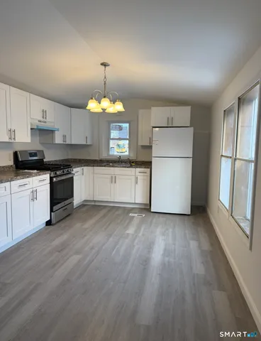 a kitchen with a stove a sink and a refrigerator