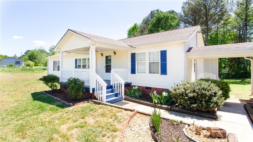 2955 Tommy Dillard Road Monroe, GA 30656 - Photo 1 of 1 a view of a house with yard and a garden