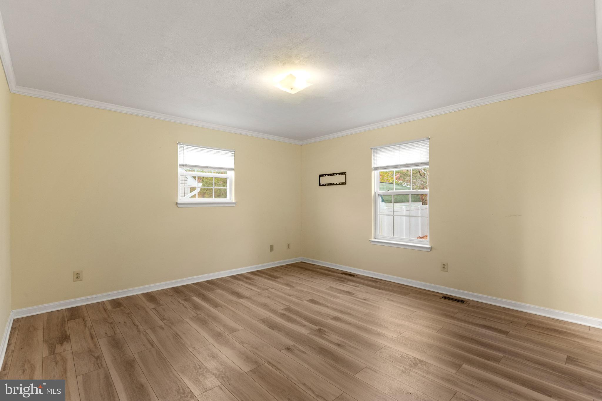 45246 Coledorall Court California, MD 20619 - Photo 11 of 21 an empty room with wooden floor and windows