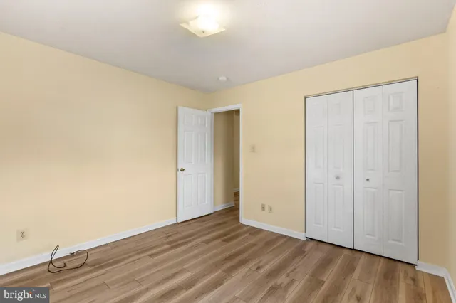 a view of an empty room and wooden floor