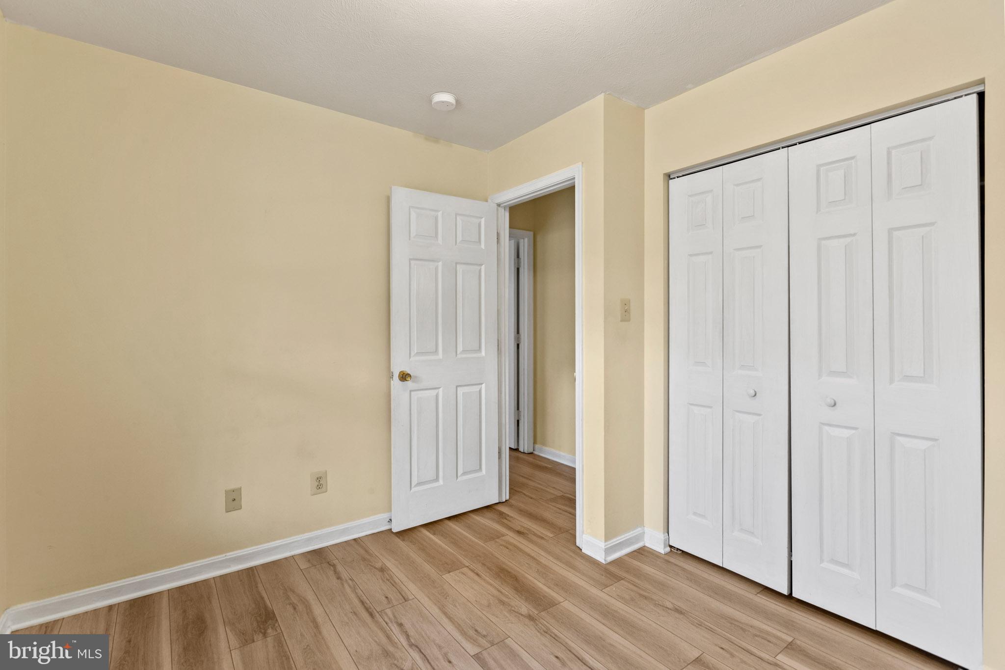 45246 Coledorall Court California, MD 20619 - Photo 13 of 21 an empty room with wooden floor and closet area