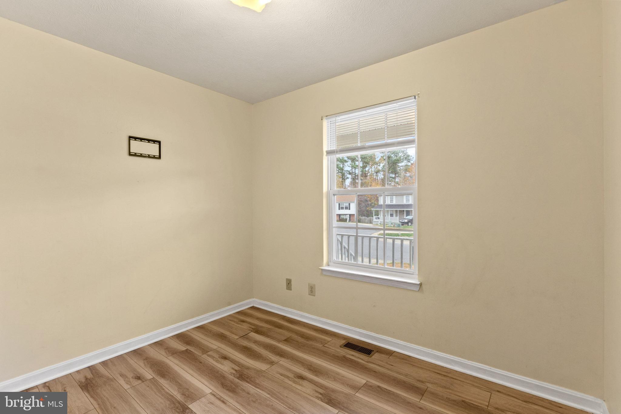 45246 Coledorall Court California, MD 20619 - Photo 14 of 21 a view of a room with wooden floor and windows