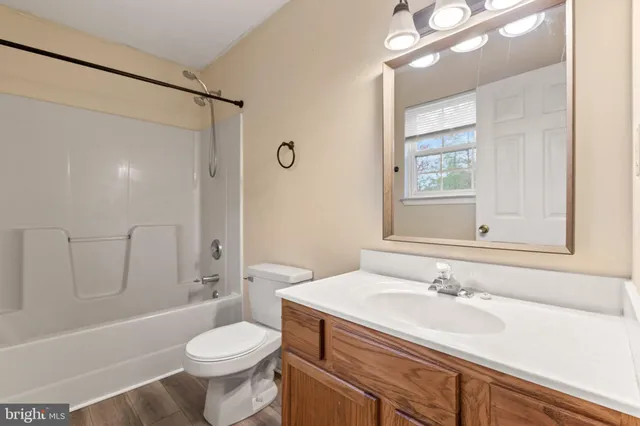 a bathroom with a sink toilet tub and shower