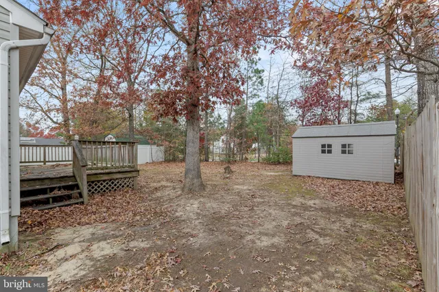 a view of a house with a yard and tree s
