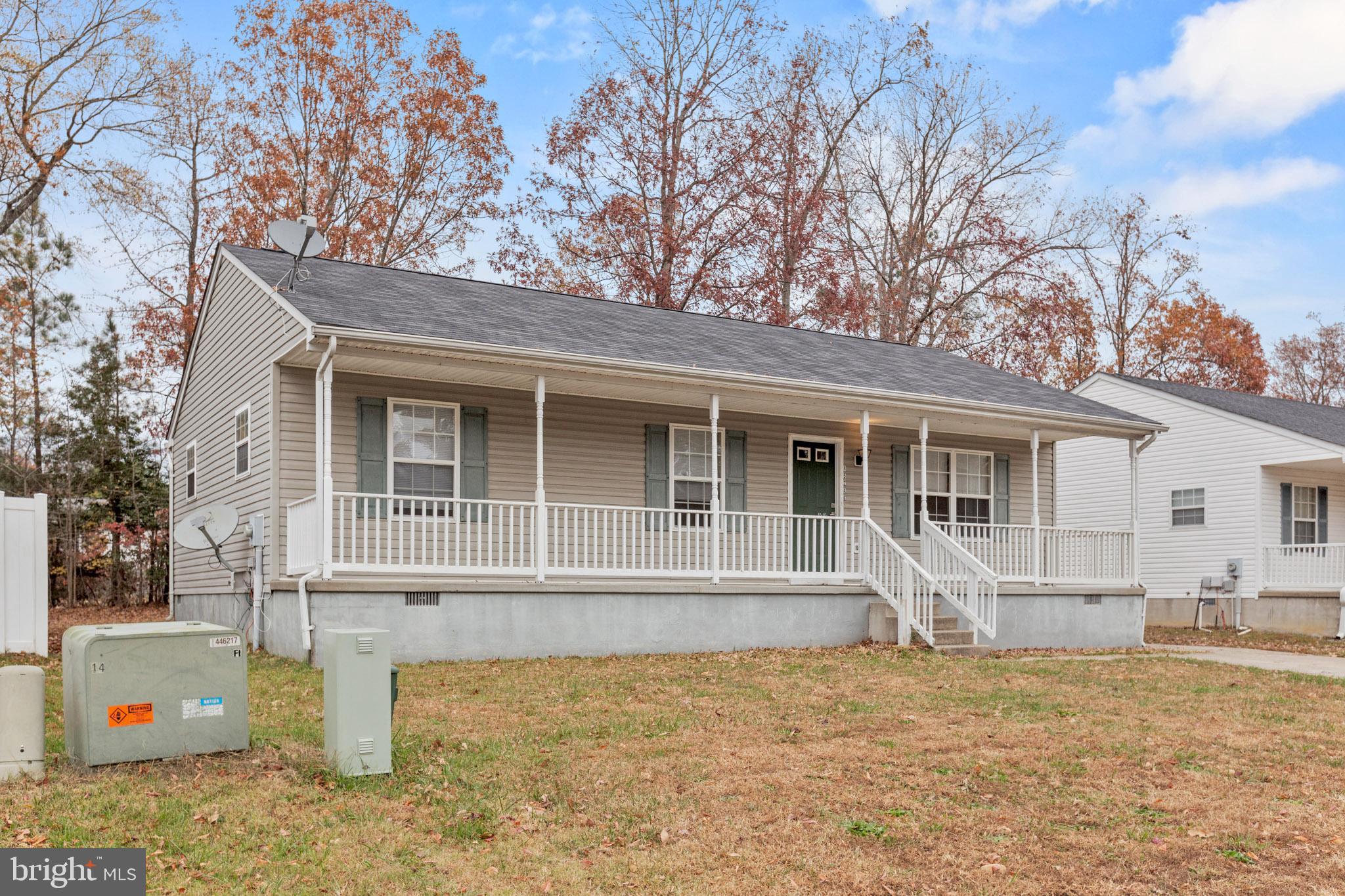 45246 Coledorall Court California, MD 20619 - Photo 3 of 21 a front view of a house with a yard and garage