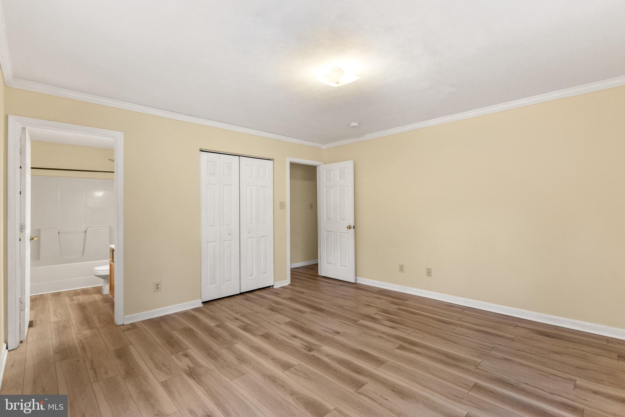 45246 Coledorall Court California, MD 20619 - Photo 10 of 21 a view of an empty room with wooden floor and a window