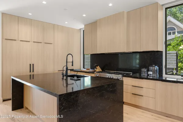 a kitchen with a sink a stove and cabinets