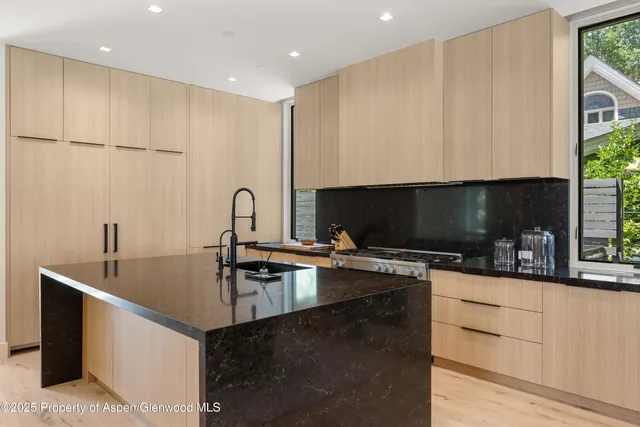 a kitchen with a sink a stove and cabinets