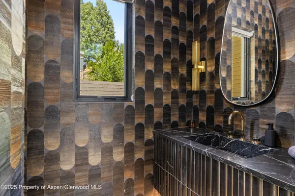 a bathroom with a mirror and a sink