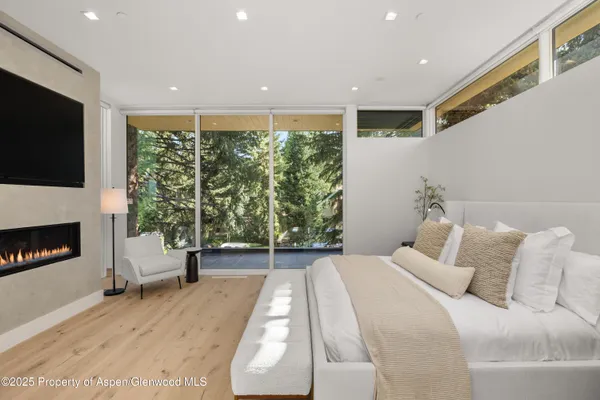 a spacious bedroom with a bed and a large window