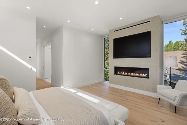 a bedroom with a bed and a night stand