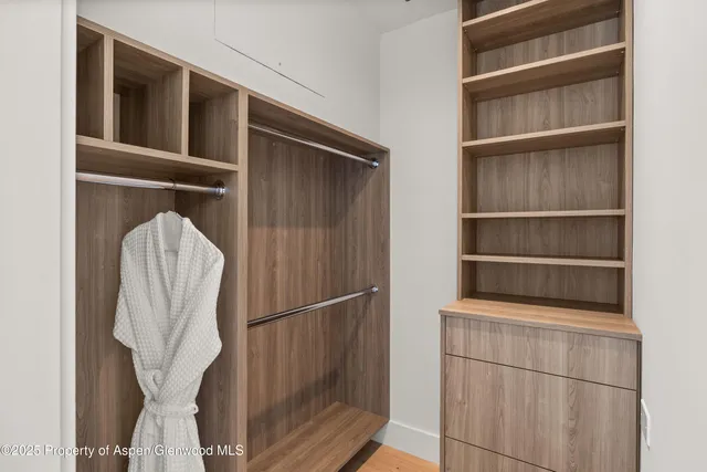 a living room with furniture a window and a flat screen tv