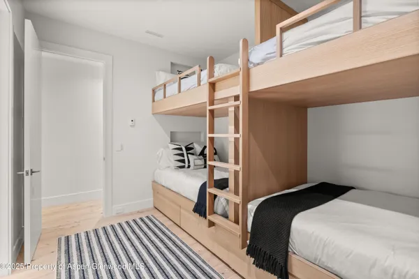 a bedroom with a bed and a flat tv screen