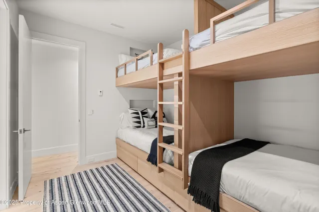 a bedroom with a bed and a flat tv screen