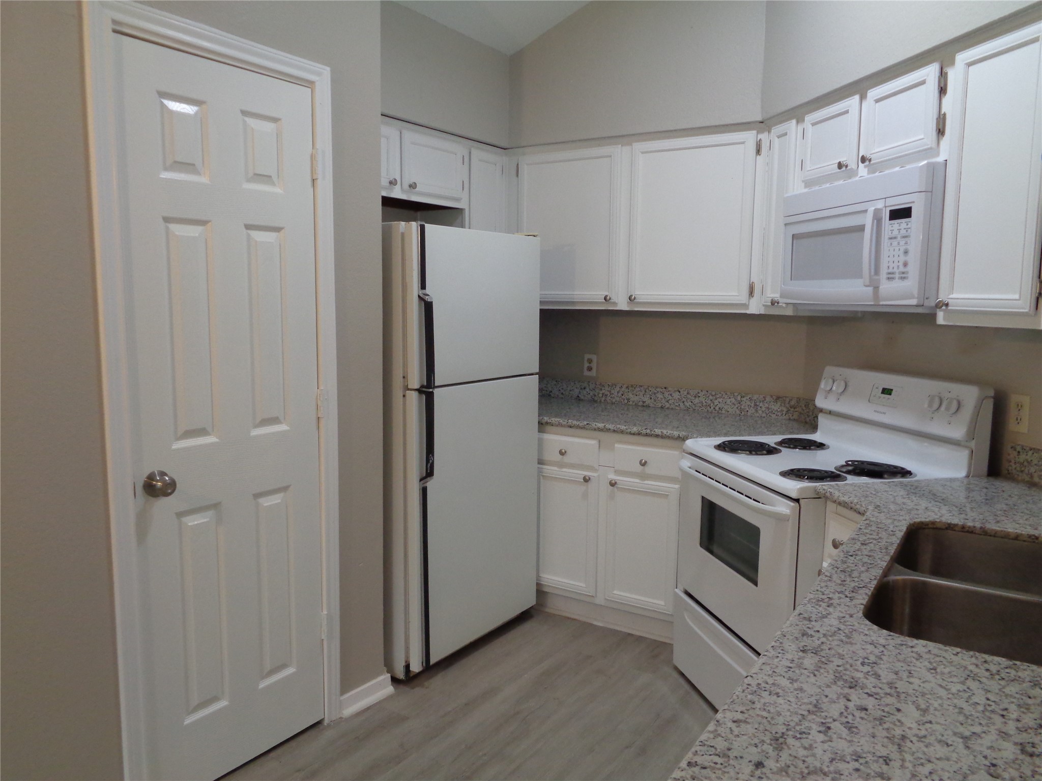 1229 Clover Drive Angleton, TX 77515 - Photo 3 of 7 a kitchen with cabinets a refrigerator and a stove