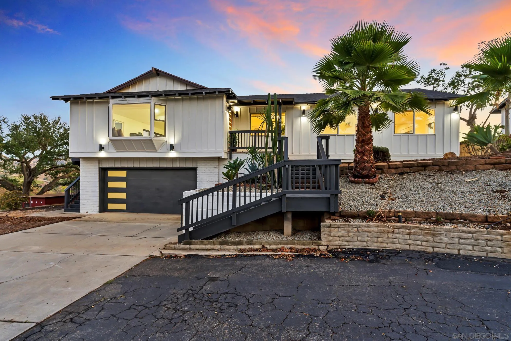 a front view of a house with a garden and yard