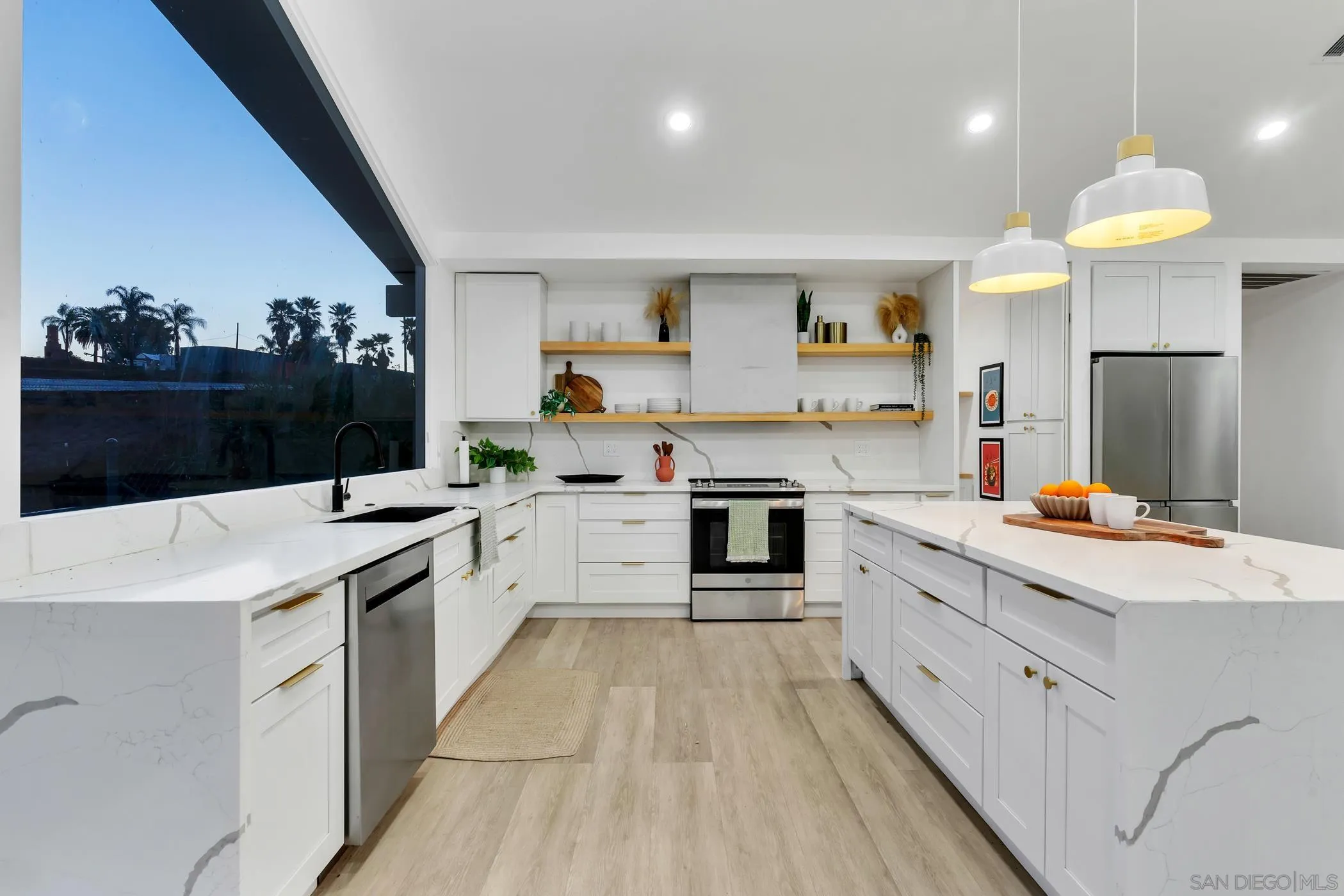 1029 Rainbow Valley Court Fallbrook, CA 92028 - Photo 15 of 75 a large kitchen with stainless steel appliances kitchen island granite countertop a stove a sink dishwasher and a refrigerator with wooden floor