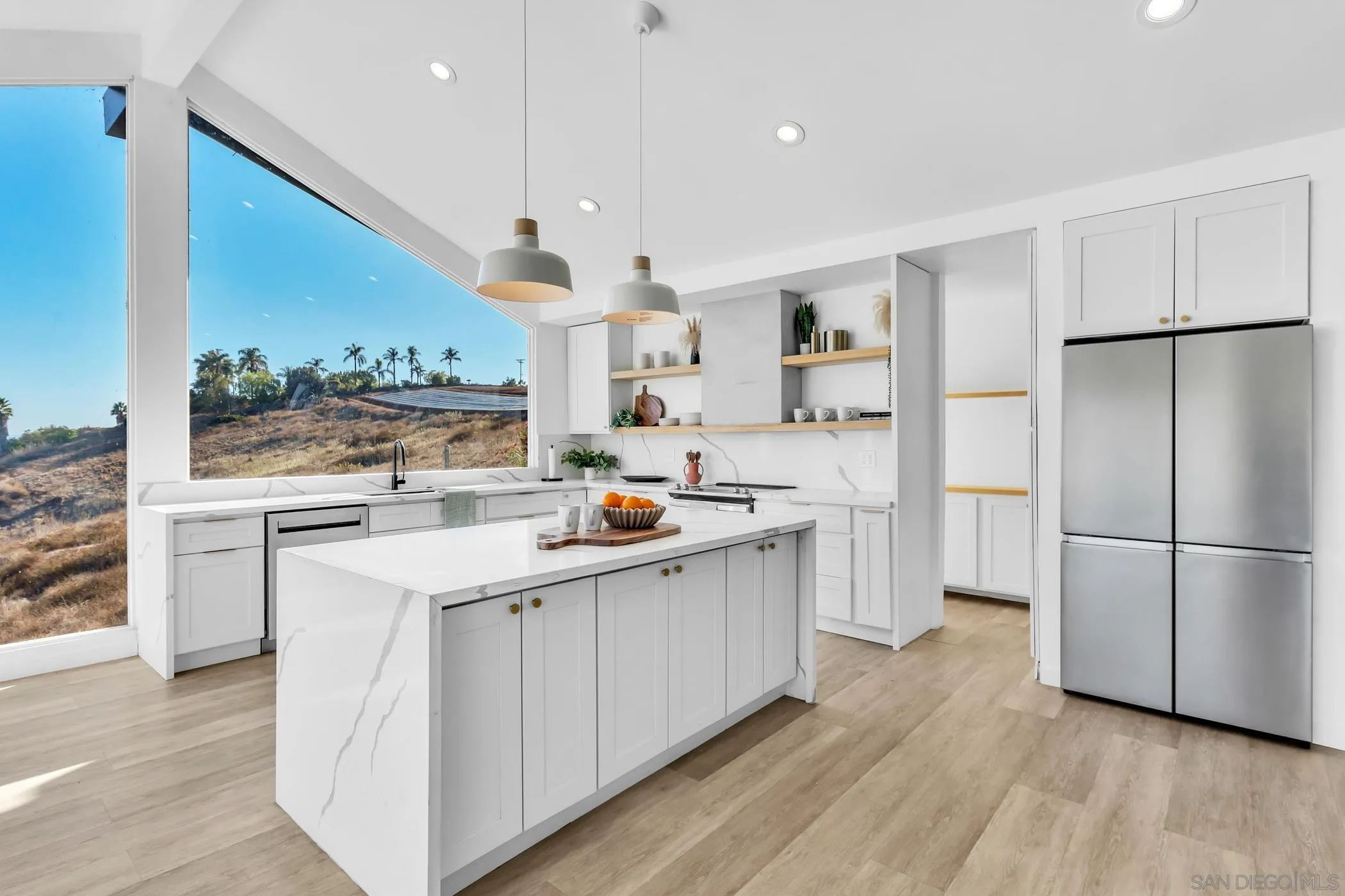 1029 Rainbow Valley Court Fallbrook, CA 92028 - Photo 35 of 75 a kitchen with white cabinets and white appliances