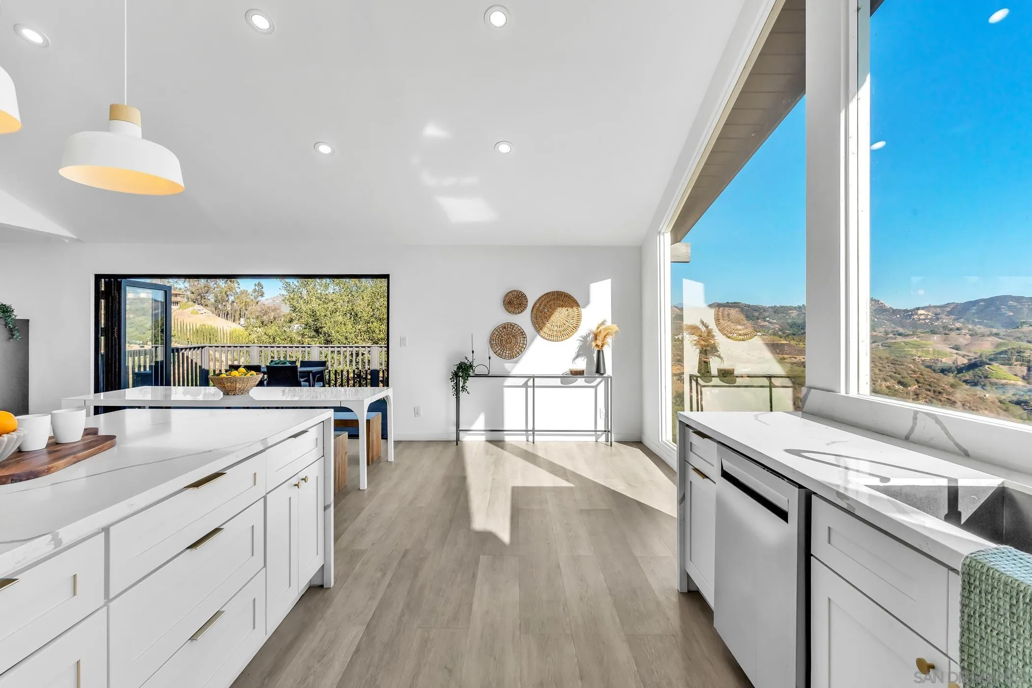 1029 Rainbow Valley Court Fallbrook, CA 92028 - Photo 40 of 75 a large kitchen with stainless steel appliances wooden floor and a large window