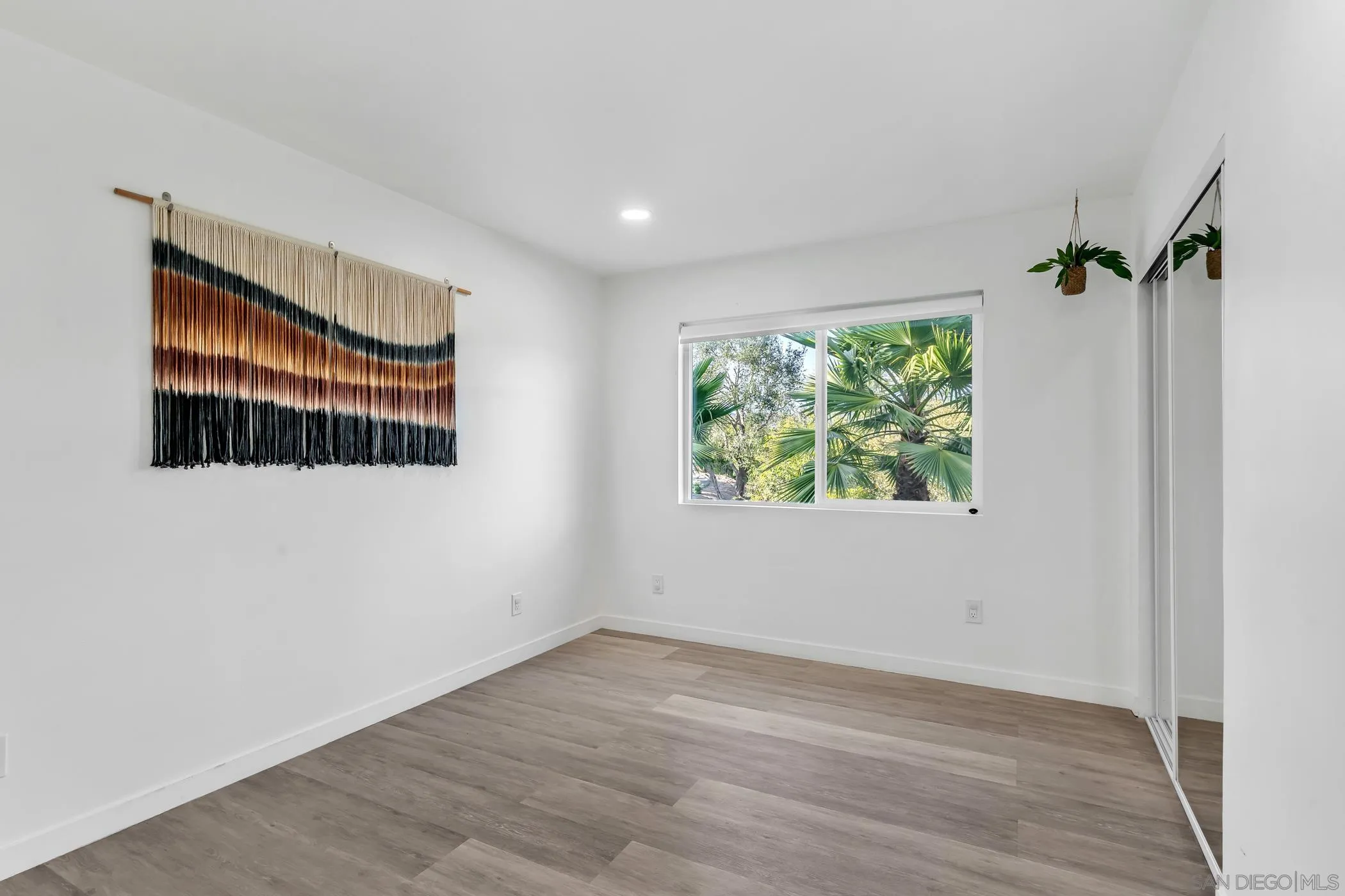 1029 Rainbow Valley Court Fallbrook, CA 92028 - Photo 45 of 75 an empty room with wooden floor and windows