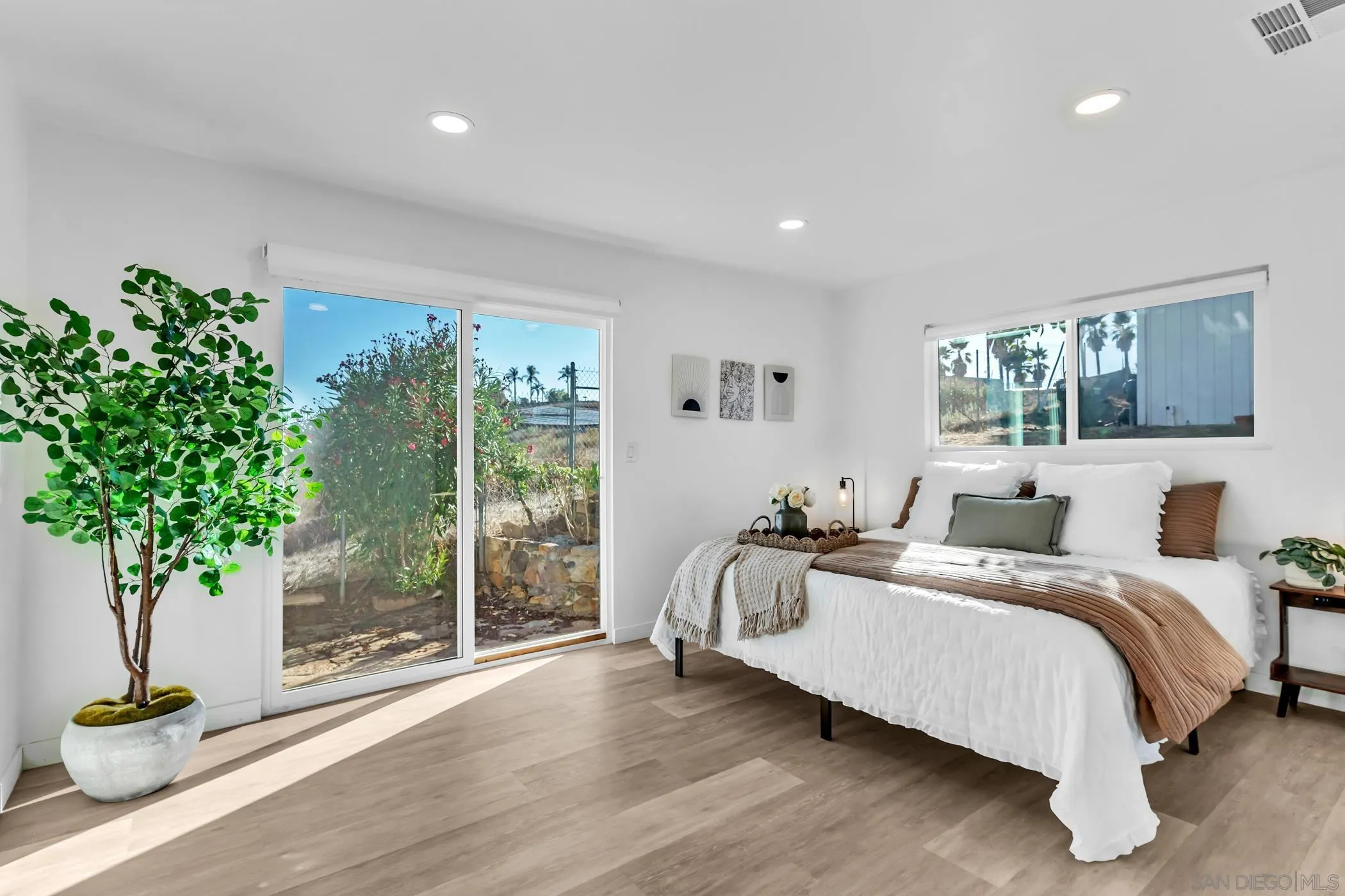 1029 Rainbow Valley Court Fallbrook, CA 92028 - Photo 48 of 75 a bedroom with a bed and a potted plant