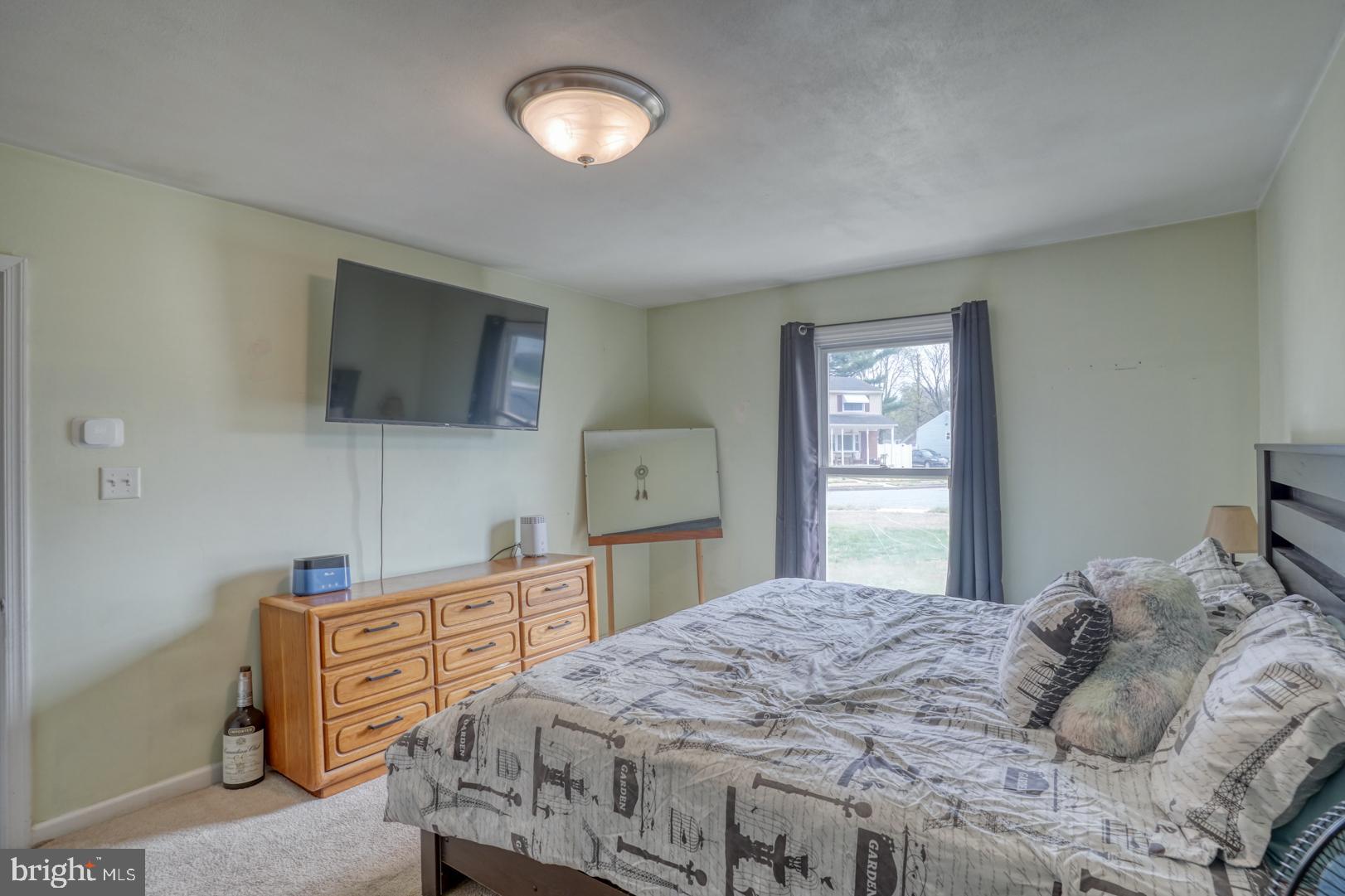 1245 Harrison Drive Dover, DE 19901 - Photo 23 of 47 a bedroom with a bed and a flat screen tv