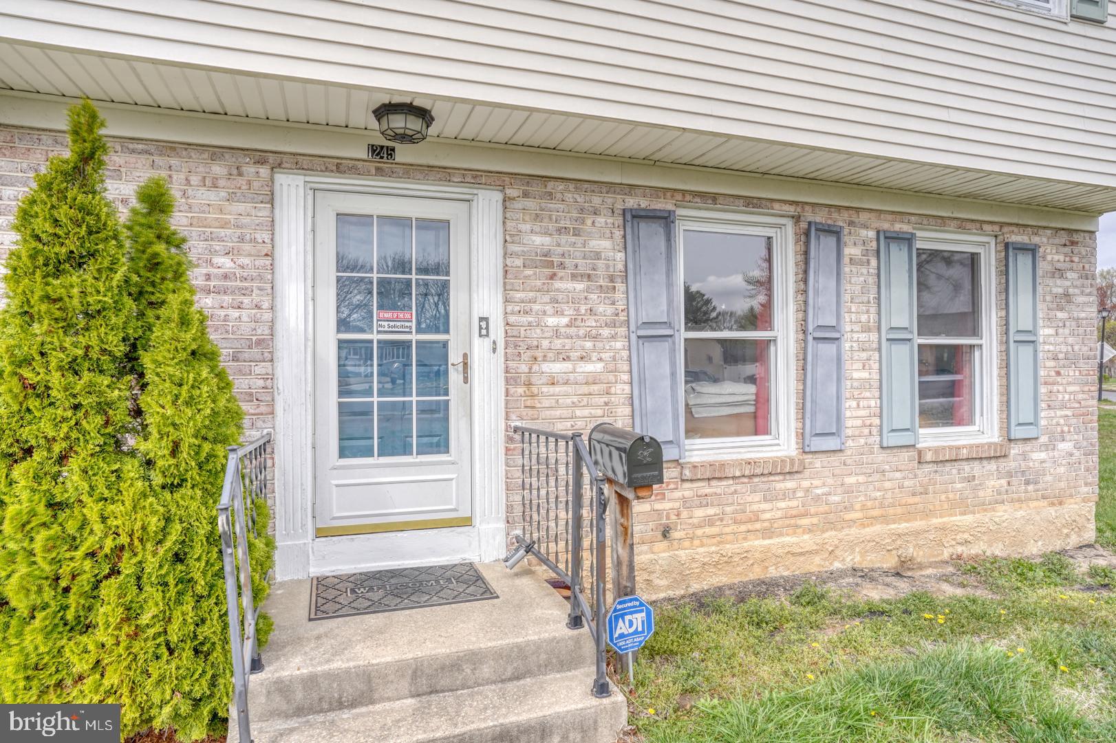 1245 Harrison Drive Dover, DE 19901 - Photo 3 of 47 a front view of a house with a yard
