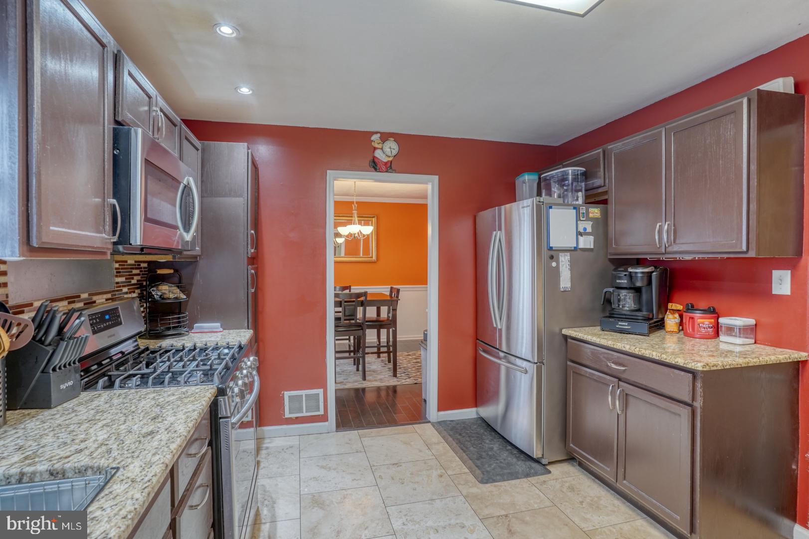 1245 Harrison Drive Dover, DE 19901 - Photo 37 of 47 a kitchen with stainless steel appliances granite countertop a refrigerator stove and sink