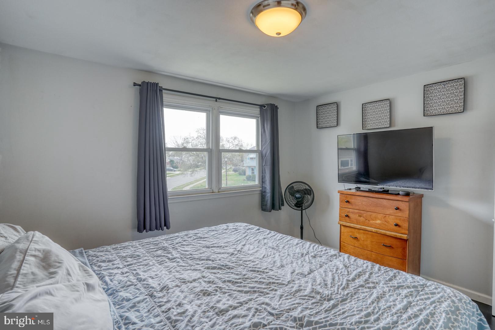 1245 Harrison Drive Dover, DE 19901 - Photo 5 of 47 a bedroom with a bed and a flat screen tv