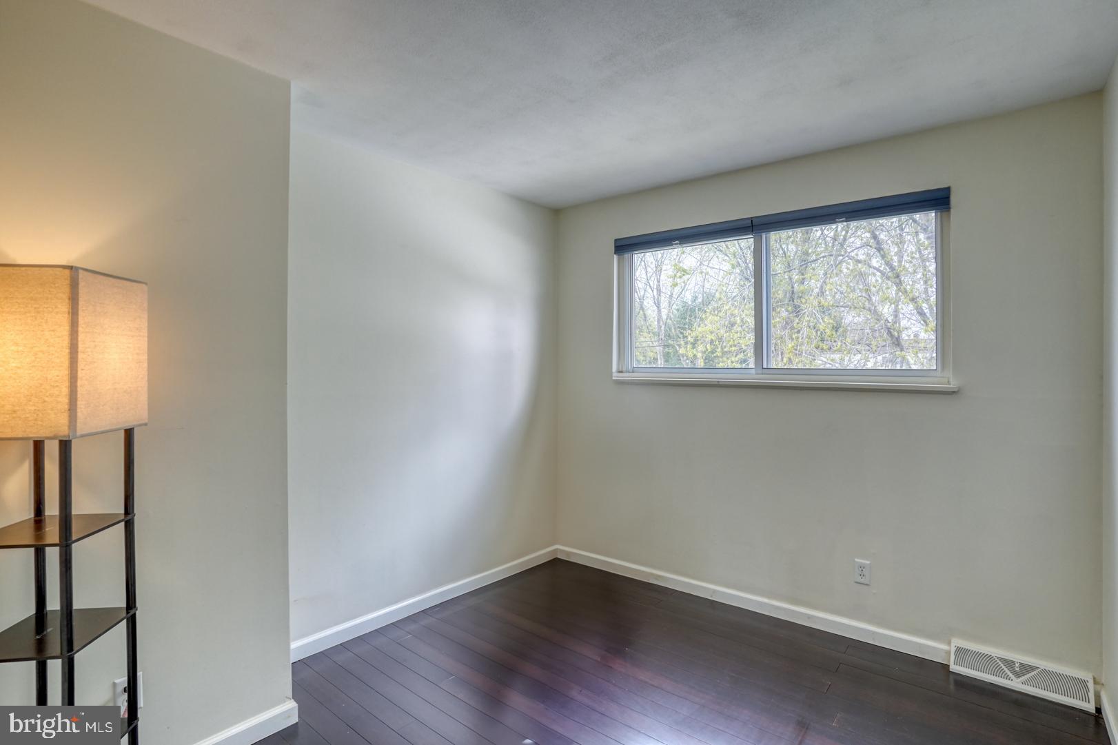 1245 Harrison Drive Dover, DE 19901 - Photo 7 of 47 an empty room with wooden floor and windows