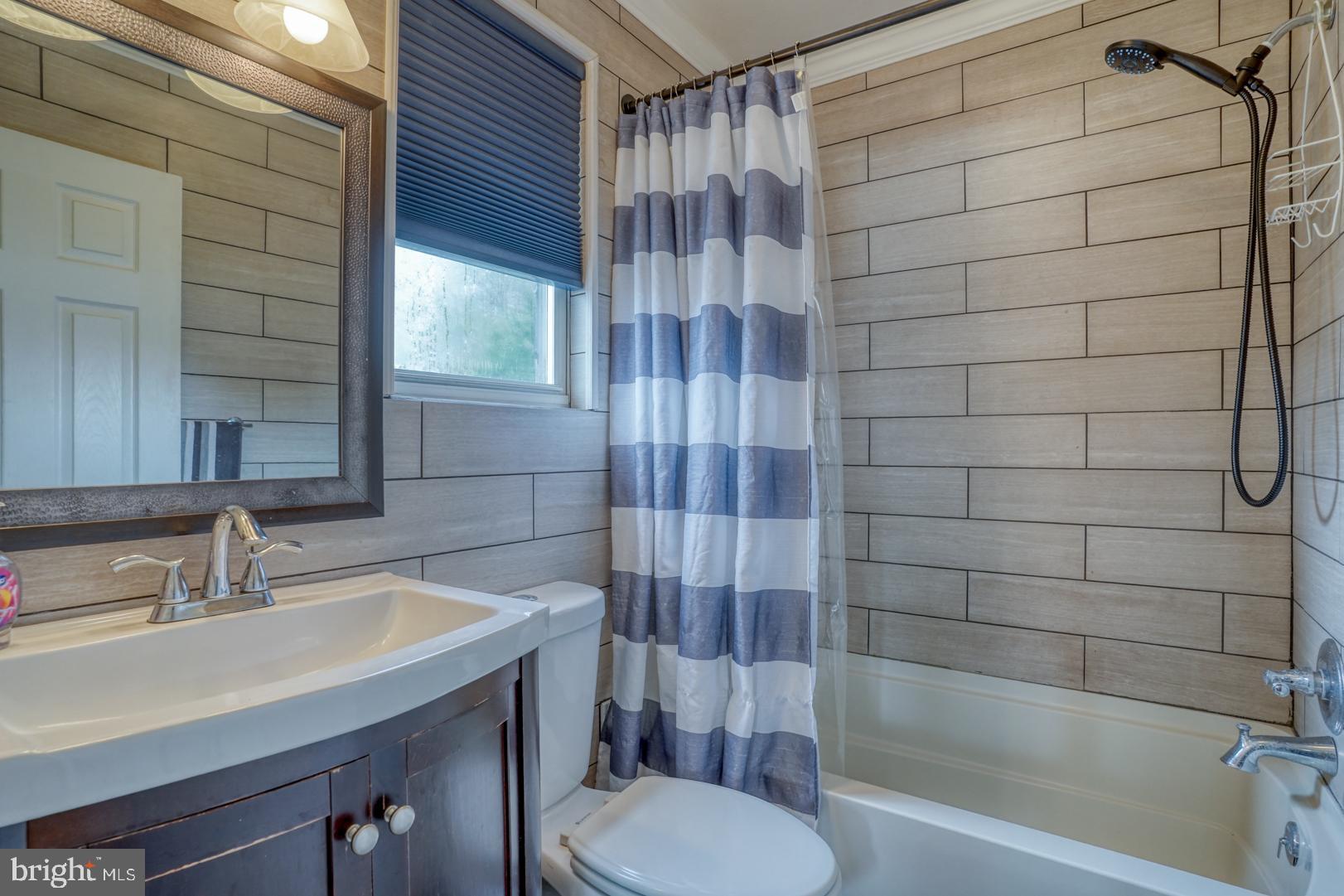 1245 Harrison Drive Dover, DE 19901 - Photo 10 of 47 a bathroom with a sink toilet and shower