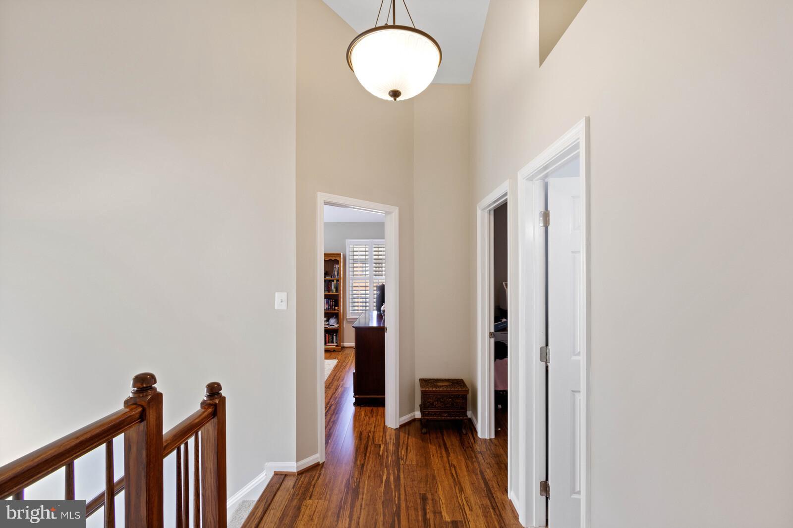 20713 Riptide Square Sterling, VA 20165 - Photo 16 of 65 a view of a hallway with wooden floor and entryway