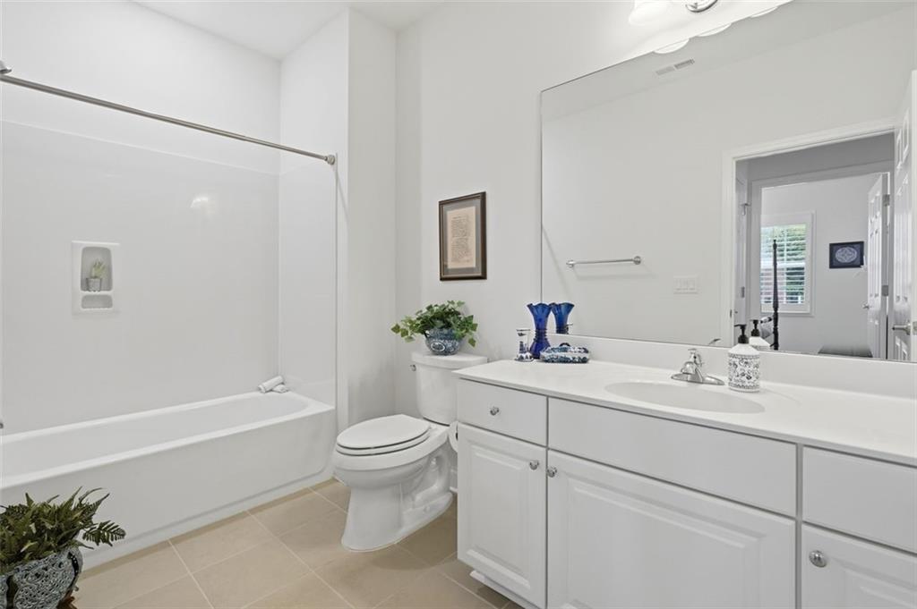 3328 Ivy Ridge Court Buford, GA 30519 - Photo 25 of 34 a bathroom with a sink a toilet and shower