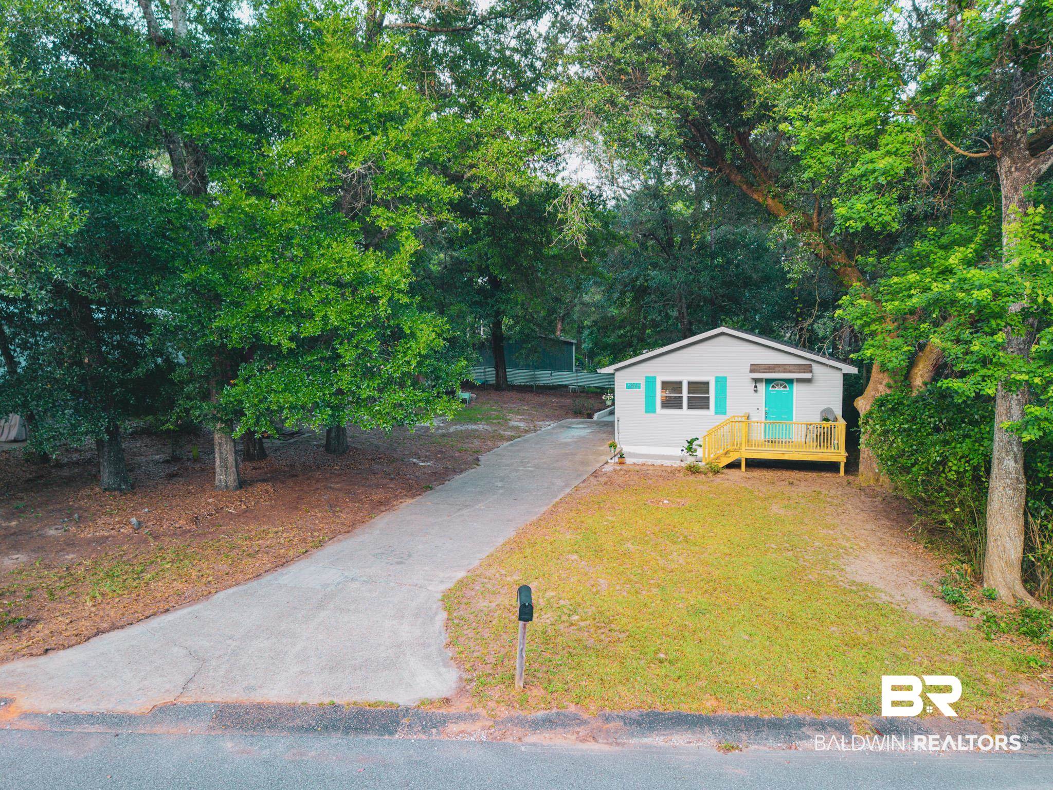 1563 Valencia Drive Lillian, AL 36549 - Photo 23 of 27 View of front of house featuring driveway and a front lawn