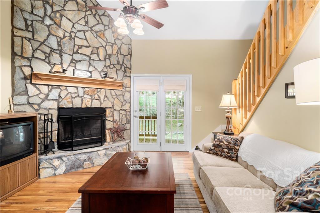 204 Nottingham Road Maggie Valley, NC 28751 - Photo 11 of 46 a living room with furniture a large window and a fireplace